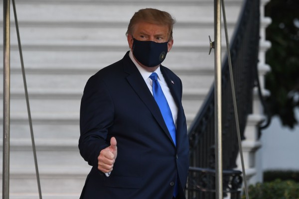 마스크를 쓴 트럼프 대통령이  병원을 향하면서 엄지를 들어보이고 있다